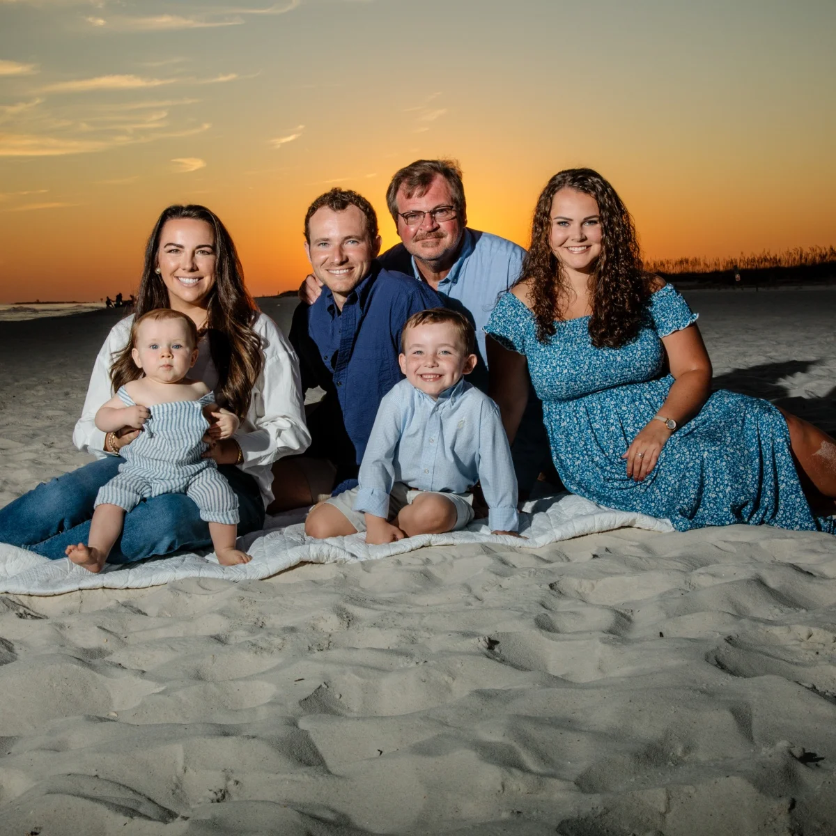 A family beach portrait session at sunset shot by Robert Phillips in the Fort Morgan, Alabama area.