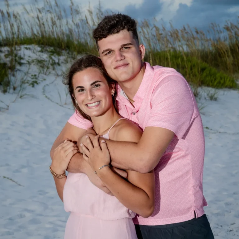 A close-up of a young couple standing on the beach during a photo session in Fort Morgan, Alabama.