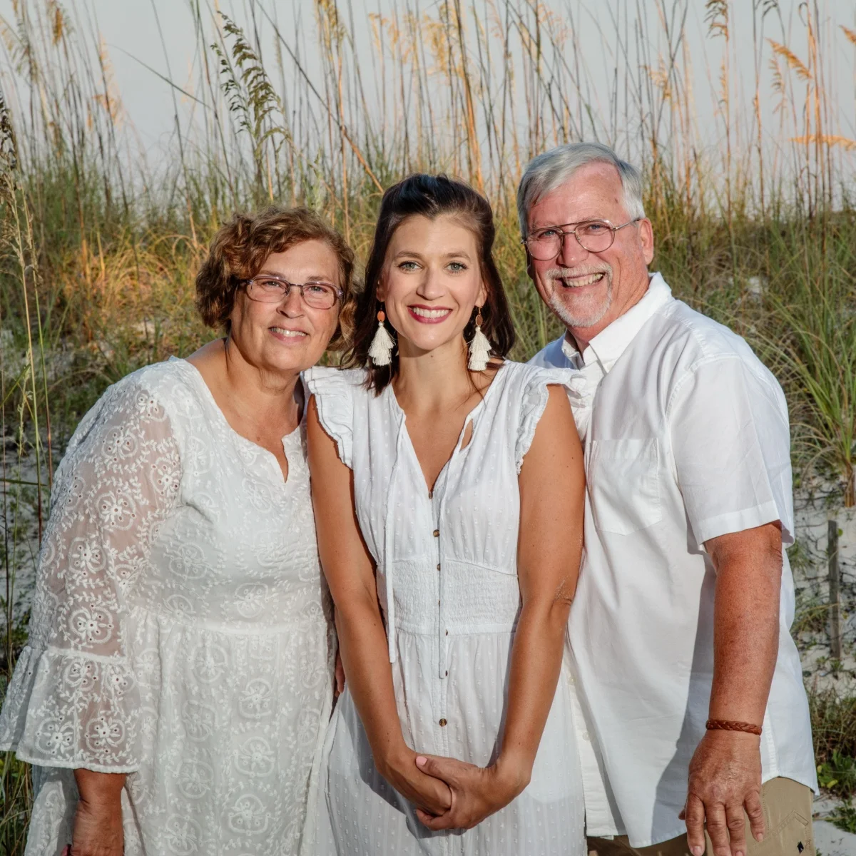 A happy photo of three family members during a photo session in Fort Morgan, Alabama.