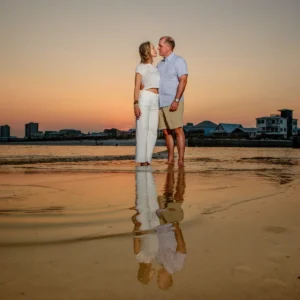 Sunset photo of a couple with a nice reflection in the water in Fort Morgan, Alabama.