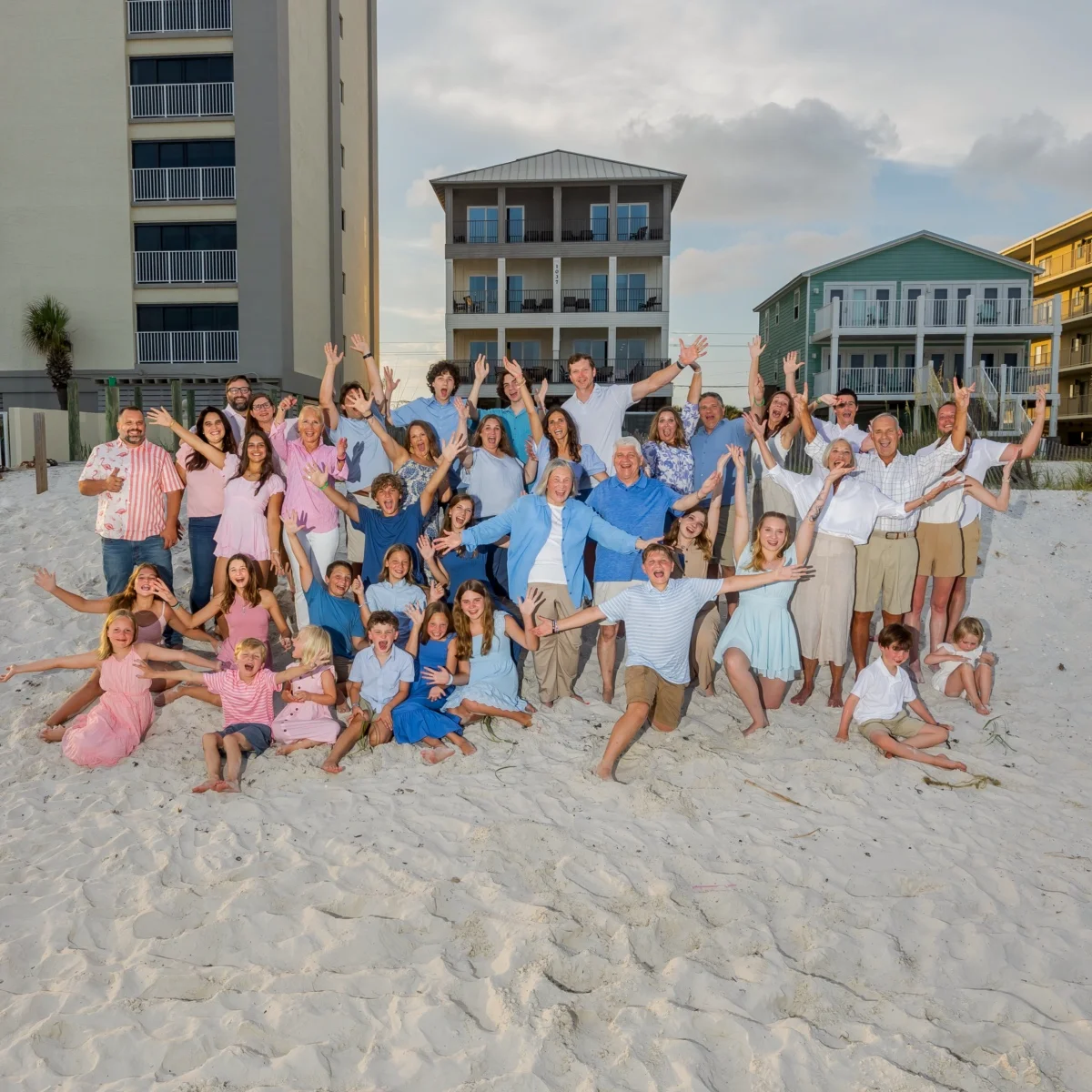 Large family beach photo in Fort Morgan, Alabama. Everyone waving happily.